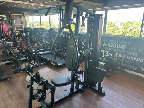 a gym with a bunch of tread machines in it at Flat Novo no Centro de Porto de Galinhas in Porto De Galinhas