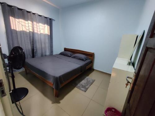 a bedroom with a bed and a window at North Area Stay Inn in Paramaribo