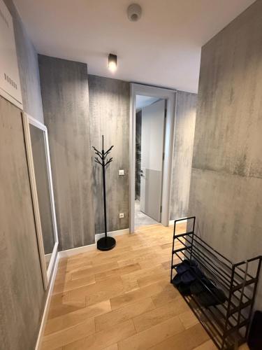 a hallway with a plant in the middle of a room at Cadordzina Apartment Free Parking Old Town in Sarajevo