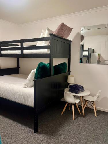 a bedroom with a bunk bed and a table at Sunny Shackell - Echuca Moama Holiday Accommodation in Echuca