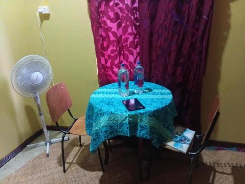 a small table with two bottles of water on it at Loa House Homestay in Lautoka