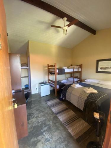 En eller flere senge i et værelse på Pousada Recanto Flor da Serra