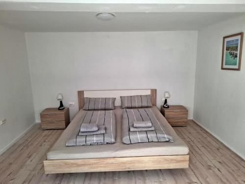 a bedroom with a large bed with two night stands at Ferienhaus Adler in Eschwege