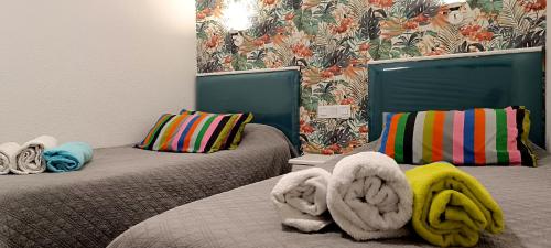 a room with two beds with towels on them at Playa del ingles Tamaran apartamento 509 in Maspalomas