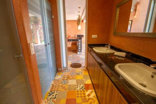 a bathroom with two sinks and a mirror at Palais pyar in Najem