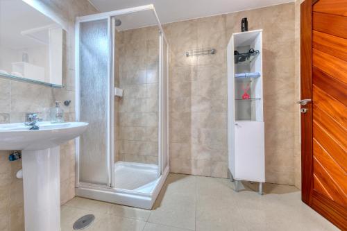 a bathroom with a shower and a sink at The mermaid House- Playa Honda in Playa Honda