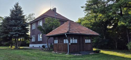 a small house with a gazebo in the grass at Private House with Sauna, Jacuzzi and Hawaiian Hothouse Spa in Velvary