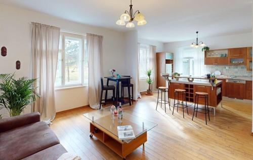 a living room with a couch and a table at Private House with Sauna, Jacuzzi and Hawaiian Hothouse Spa in Velvary