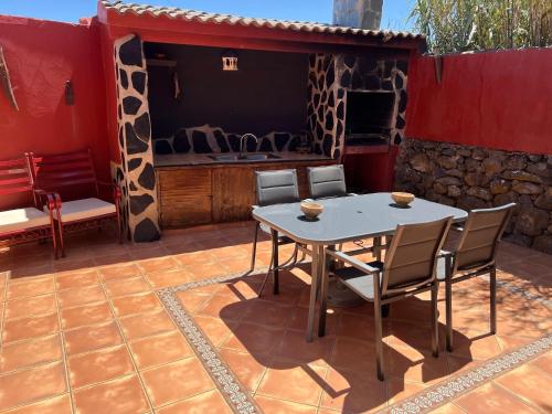 a patio with a table and chairs on a patio at Casa La Gollada in Cazadores