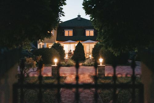 a house with lights in front of it at night at Villa Maranga in Dombóvár