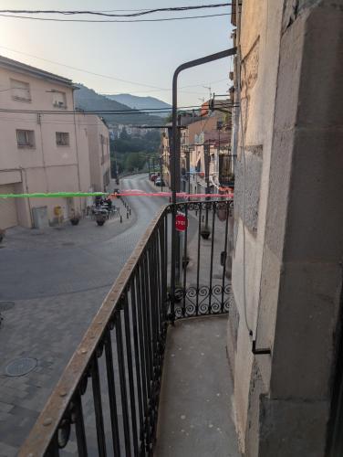 a view of a street from a balcony of a building at Ca l'Emília, hasta 6 pers, Monistrol de Montserrat in Monistrol