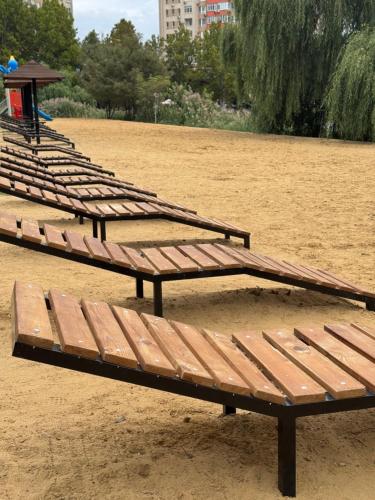 a row of benches sitting in a park at Panoramic Lake View in Chişinău
