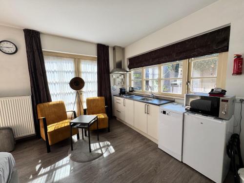 a kitchen with a sink and a counter top at Appartement Villa Eva Rosa in Wijk aan Zee