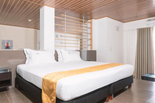 Postel nebo postele na pokoji v ubytování Waira Suites