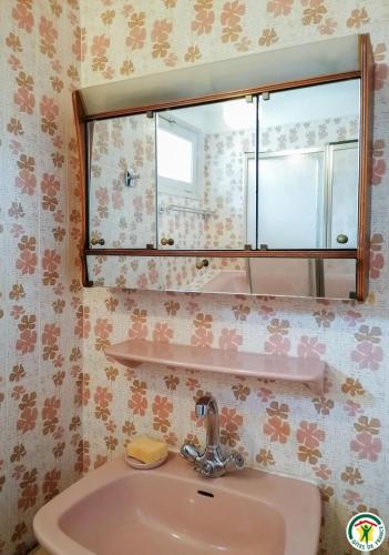 a bathroom with a sink and a mirror at Au village in Boutx