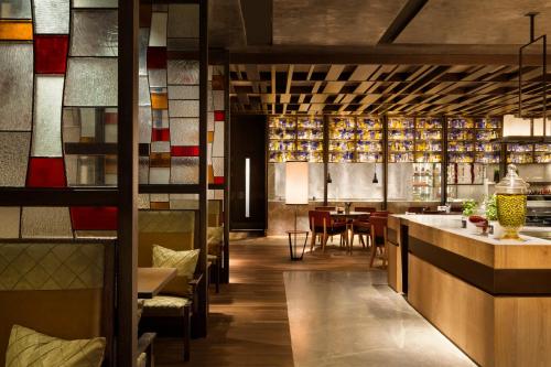 a restaurant with a bar and a dining room at Midtown Shangri-La, Hangzhou - around 5 minutes walking distance to West Lake in Hangzhou