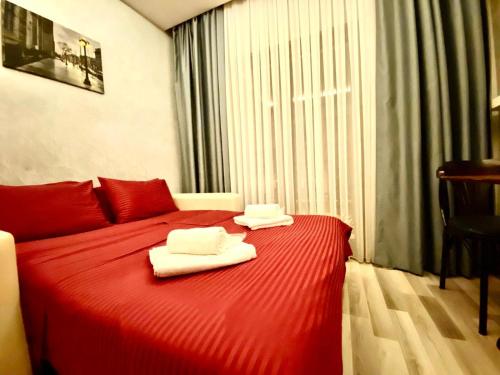two towels on a red bed in a room at Deluxe Vista Suit Hotel Taksim in Istanbul