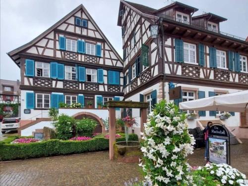 a building with blue windows and a sign in front of it at Ferienwohnungen St Marien in Gengenbach