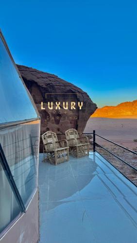 a view of a building with chairs on the roof at RUM CROWD DARLiNG LUXURY in Wadi Rum