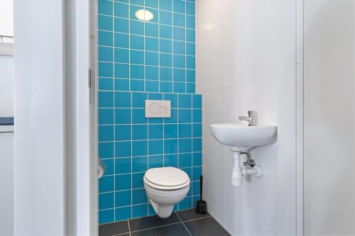 a bathroom with a toilet and a sink at Weststraat 22 - Ouddorp - Appartement Oost 3P in Ouddorp