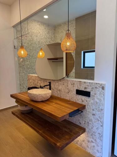 a bathroom with a sink and a mirror at Julim Flora - Eco Villa in Amed