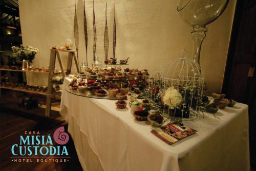 a table with a bunch of cupcakes on it at Misia Custodia Hotel Boutique in Barichara