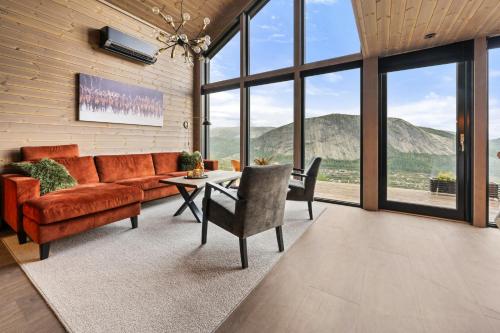 a living room with a couch and a table at Authentic Cabin Life With Løefjell View in Rysstad