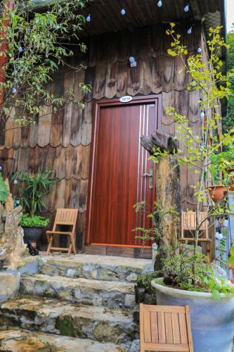 a wooden door of a house with a stone stairs at Sapa Succulent Garden Homestay in Sa Pa