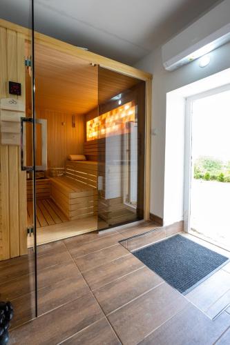 a sauna with a glass door in a room at Apartman Berlin Sokobanja 2 in Soko Banja