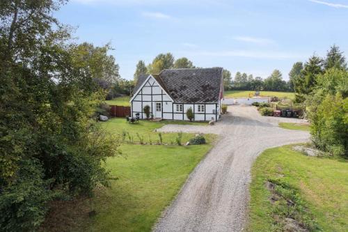 an aerial view of a house on a gravel road at Timber-Frame Holiday Flat Near Beach in Vålse