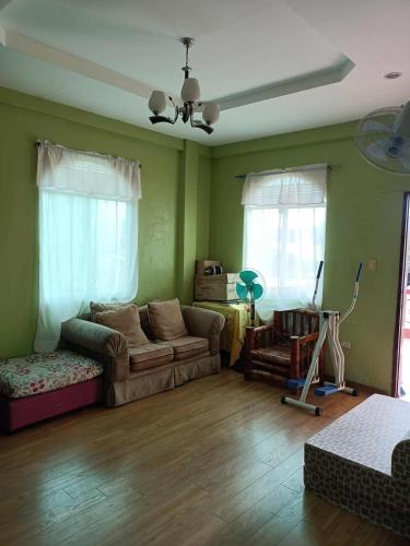 a living room with a couch and a chair at Joel's House in Iloilo City