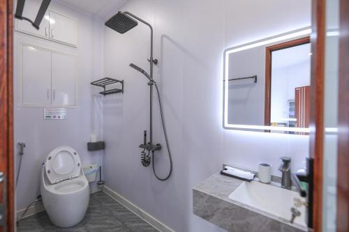a bathroom with a shower and a toilet and a sink at Sapa Succulent Garden Homestay in Sa Pa