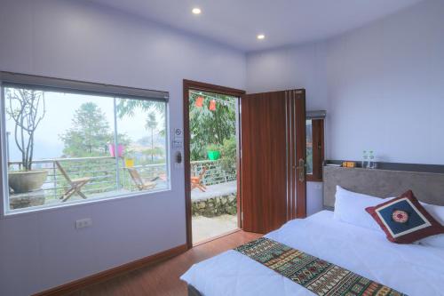 a bedroom with a bed and a large window at Sapa Succulent Garden Homestay in Sa Pa