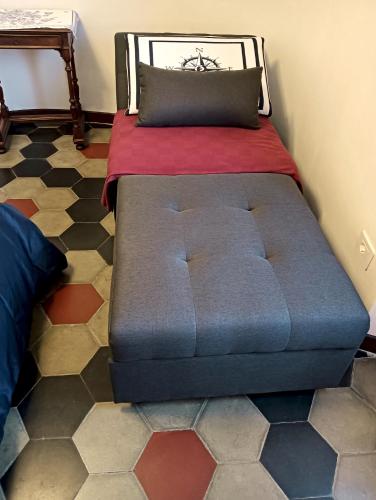 a bed sitting in a room with a bed sqor at Lake Como Windrose - Rosa dei Venti in Bellano