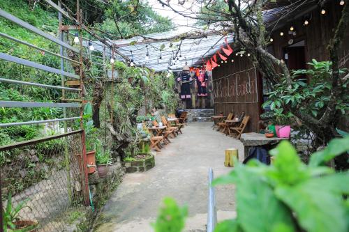 a patio with wooden tables and chairs and plants at Sapa Succulent Garden Homestay in Sa Pa
