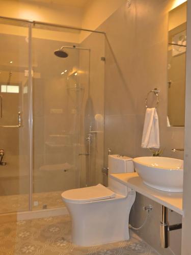 a bathroom with a toilet and a sink and a shower at Mundoota House in Jaipur