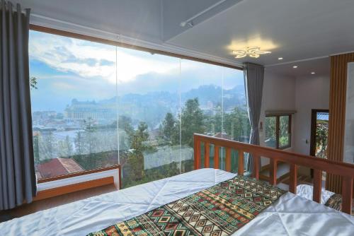 a bedroom with a bed and a large window at Sapa Succulent Garden Homestay in Sa Pa