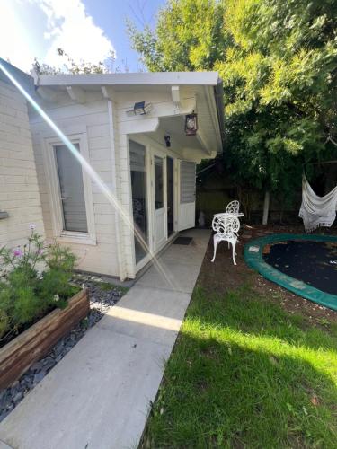 a patio with a white bench next to a house at 29 Park Avenue , Shoreham-by-Sea , Cozy Cabin in Shoreham-by-Sea