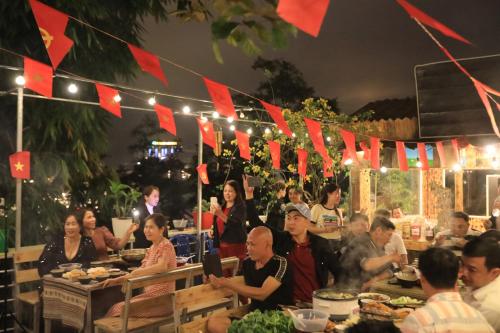 a group of people sitting at tables in a restaurant at Sapa Succulent Garden Homestay in Sa Pa
