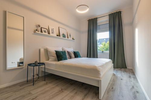 a bedroom with a large bed with a window at business or holiday in Wiesbaden