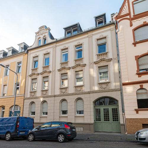 a building with two cars parked in front of it at business or holiday in Wiesbaden