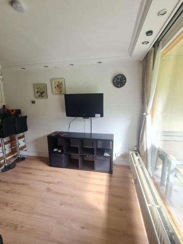 a living room with a flat screen tv on the wall at Pause Nature N in La Calamine