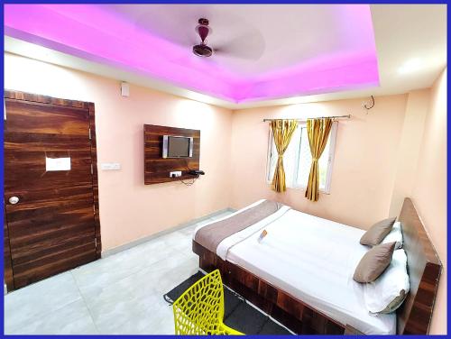 a bedroom with a bed with a purple ceiling at Hotel Priyanshi Aradhya Shree Jagannath Temple - Free Wifi and Parking Facilities - Fully-Air-Conditioned Rooms - Best Hotel in Gaya