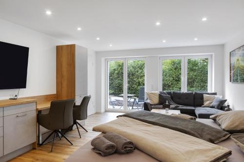 a living room with a bed and a couch at Ferienwohnung 1 Coburg-Creidlitz in Coburg