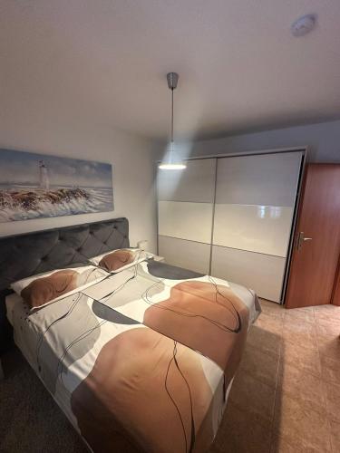a bedroom with a large bed in a room at Apartment Nina in Biograd na Moru