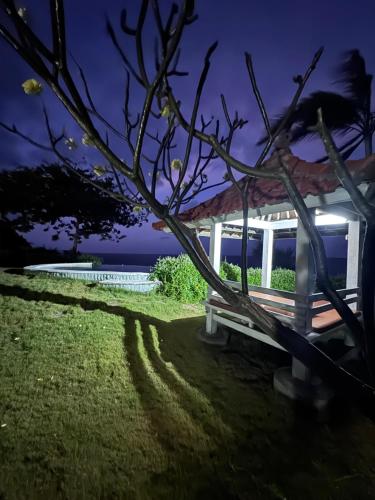 a white gazebo sitting in the grass at night at Makawi Tuwa in Seraya