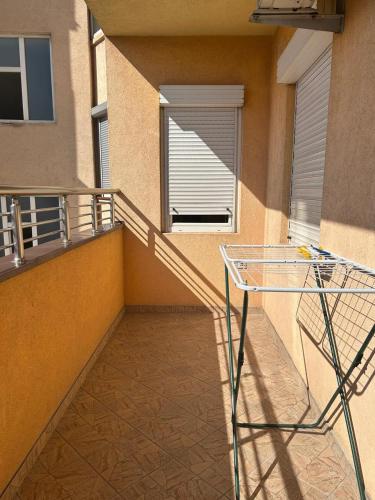 a balcony with a glass table and a window at Relax in Tetovo