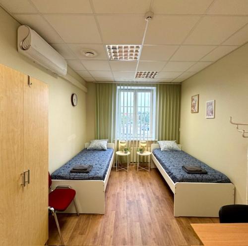 a room with two beds and a table in it at ATB9 Guest House in Valga