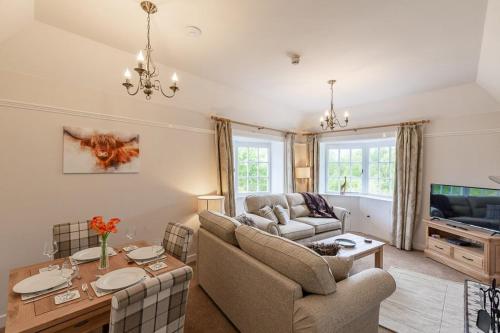 a living room with a couch and a table at Lonan Country House and Gardens in Taynuilt