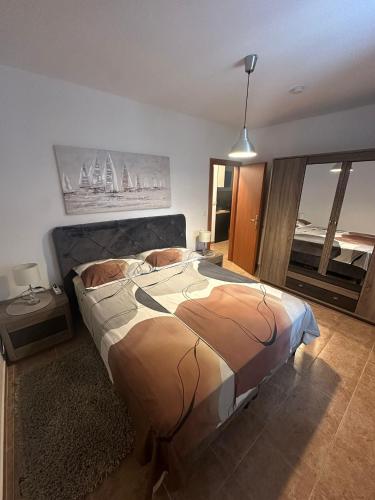 a bedroom with a large bed in a room at Apartment Nina in Biograd na Moru